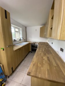 wooden kitchen with white sink